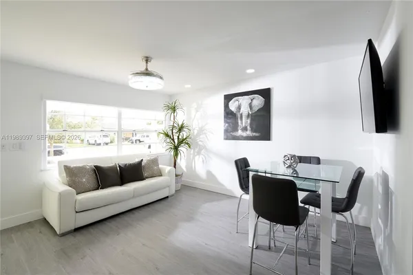 a living room with furniture a large window and a flat screen tv