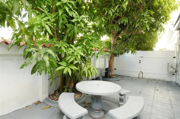 a white toilet sitting in a backyard