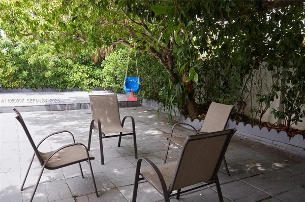 a view of a chairs and table in the patio