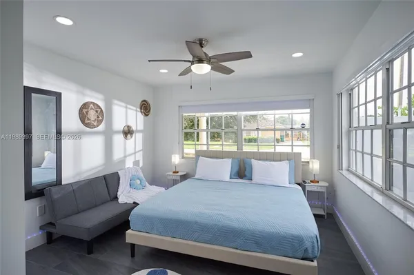 a bedroom with a large bed and a chandelier