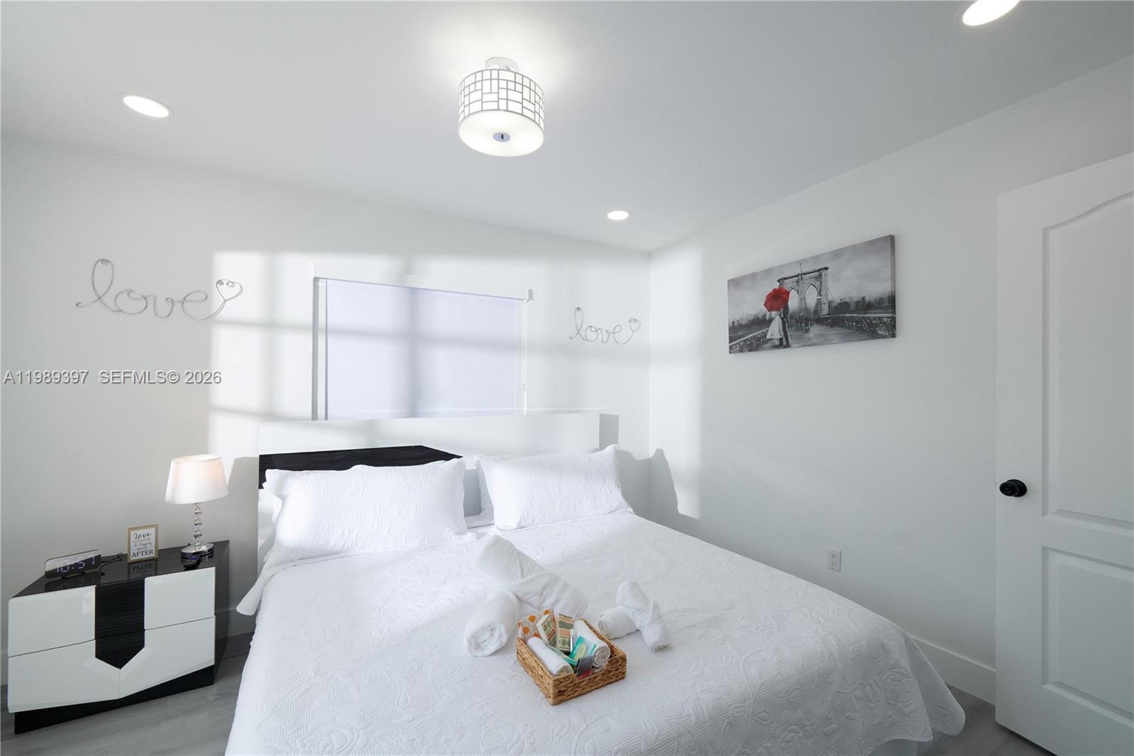 12293 Southwest 28th Terrace Miami, FL 33175 - Photo 9 of 25 a bedroom with a bed and a chandelier