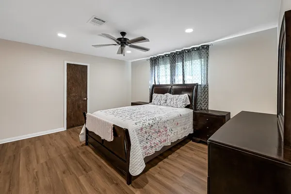 a bedroom with a bed and a window