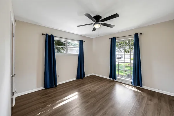 a view of a livingroom with a window and wooden floor