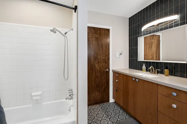 a bathroom with a bathtub and a sink