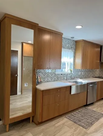 a view of living room with granite countertop cabinets and fireplace