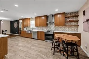 a kitchen with kitchen island granite countertop wooden cabinets and chairs