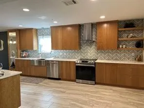 a large kitchen with stainless steel appliances kitchen island granite countertop a sink and cabinets