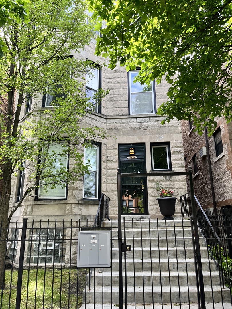 4918 South St Lawrence Avenue, Unit 3 Chicago, IL 60615 - Photo 1 of 16 front view of a house with a balcony