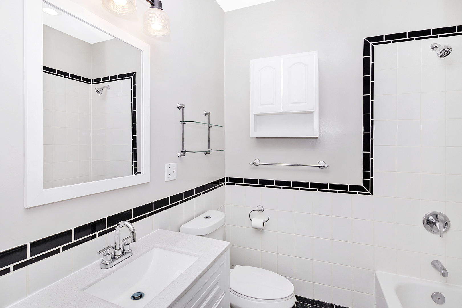 4918 South St Lawrence Avenue, Unit 3 Chicago, IL 60615 - Photo 12 of 16 a bathroom with a sink a toilet and a mirror