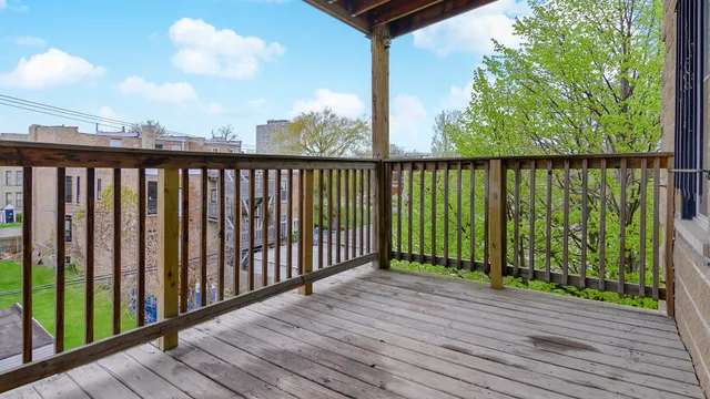 a view of a balcony with wooden floor