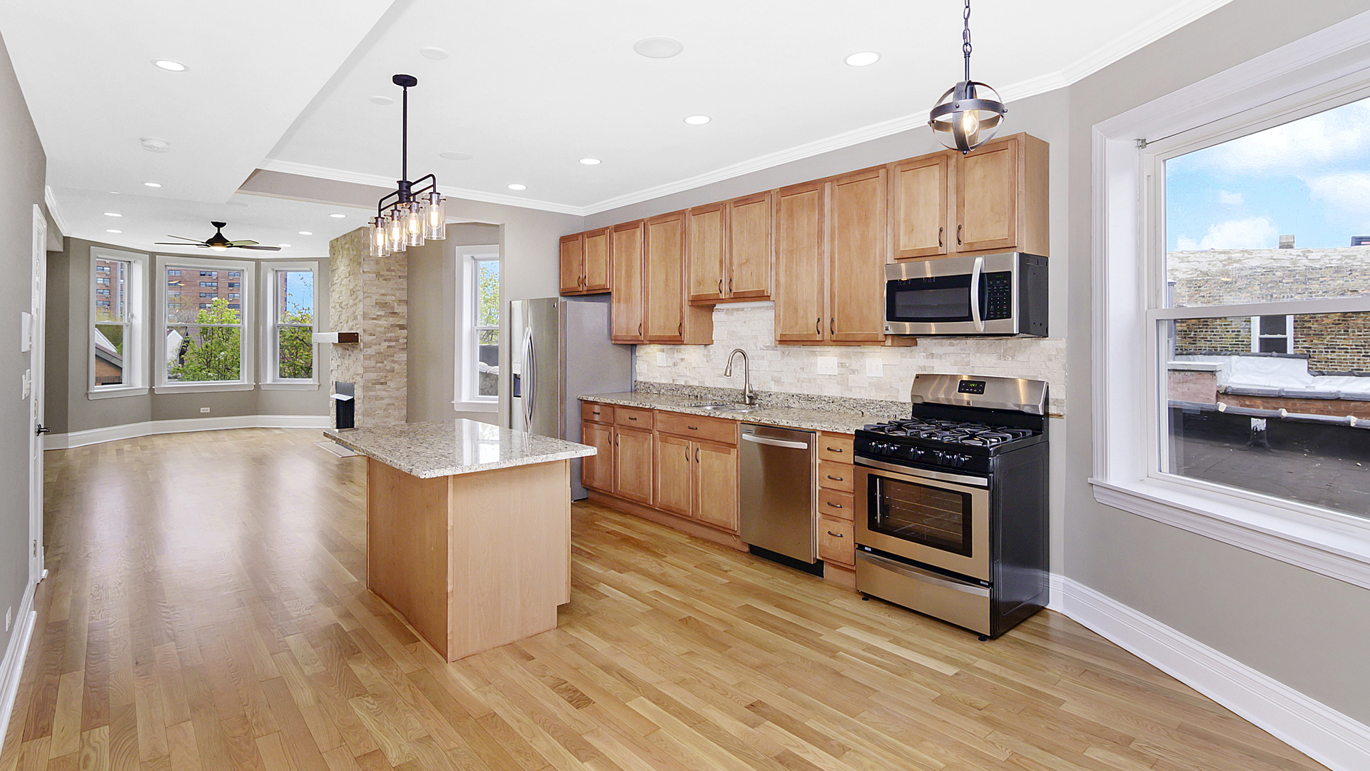 4918 South St Lawrence Avenue, Unit 3 Chicago, IL 60615 - Photo 6 of 16 a kitchen with stainless steel appliances a stove top oven a sink dishwasher a refrigerator and a dining table with wooden floor