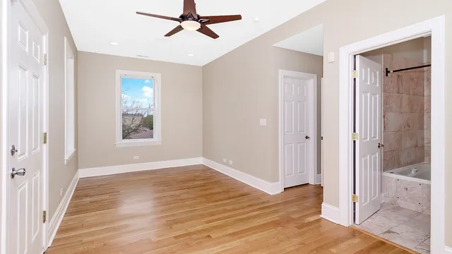 a view of a room with wooden floor and window