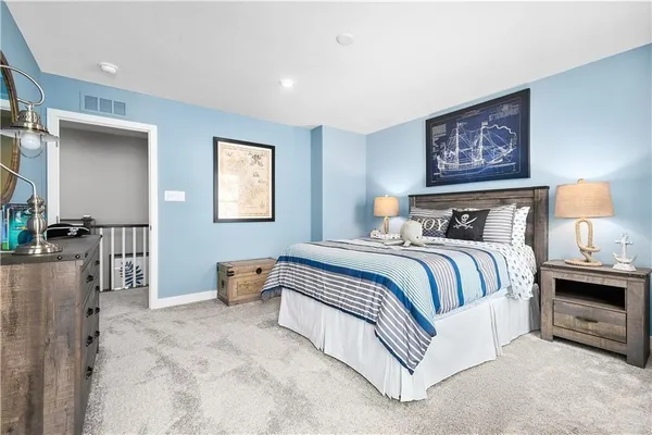 a spacious bedroom with a large bed and a chandelier