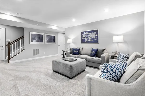 a living room with furniture and a night stand