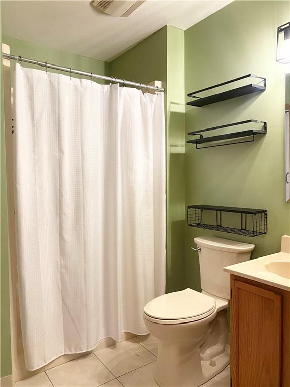 804 Barbra Lane New Castle, PA 16101 - Photo 14 of 16 a white toilet sitting next to a shower curtain