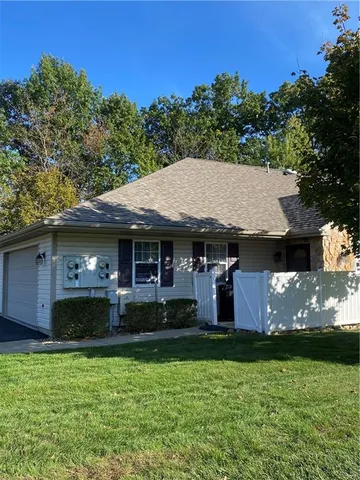 an aerial view of a house with garden space and a patio