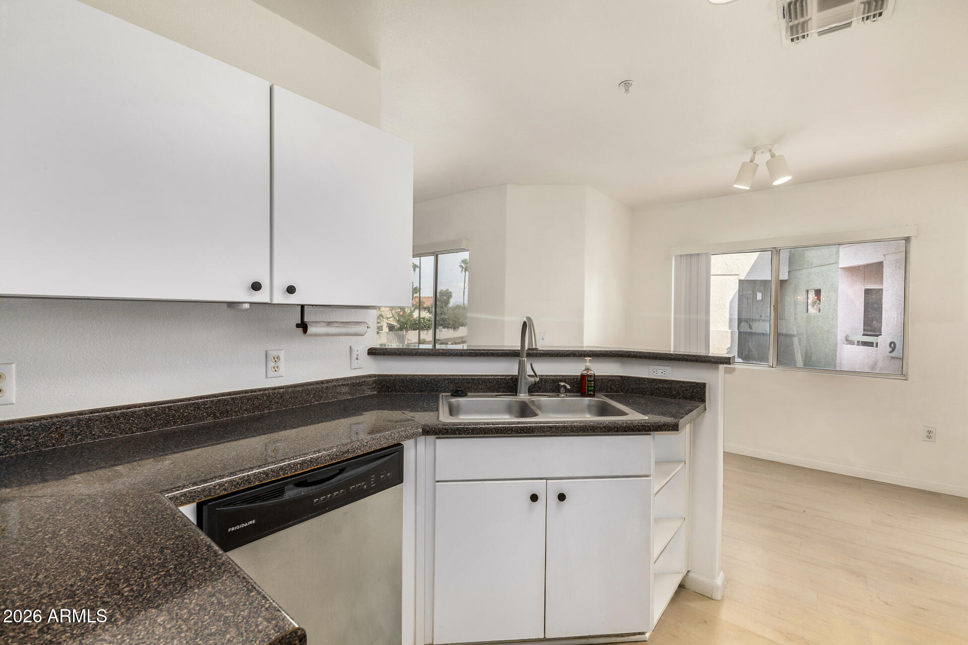 1295 North Ash Street, Unit 828 Gilbert, AZ 85233 - Photo 6 of 43 a kitchen with stainless steel appliances granite countertop a sink stove and cabinets