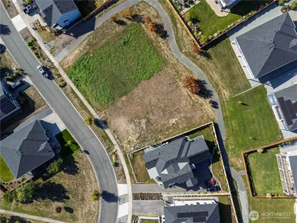 an aerial view of a residential houses with outdoor space