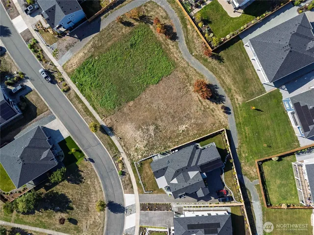 an aerial view of a residential houses with outdoor space