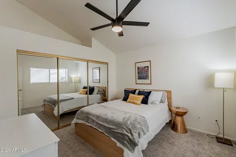 a bedroom with two beds and ceiling fan