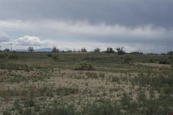 a view of a lake and green valley