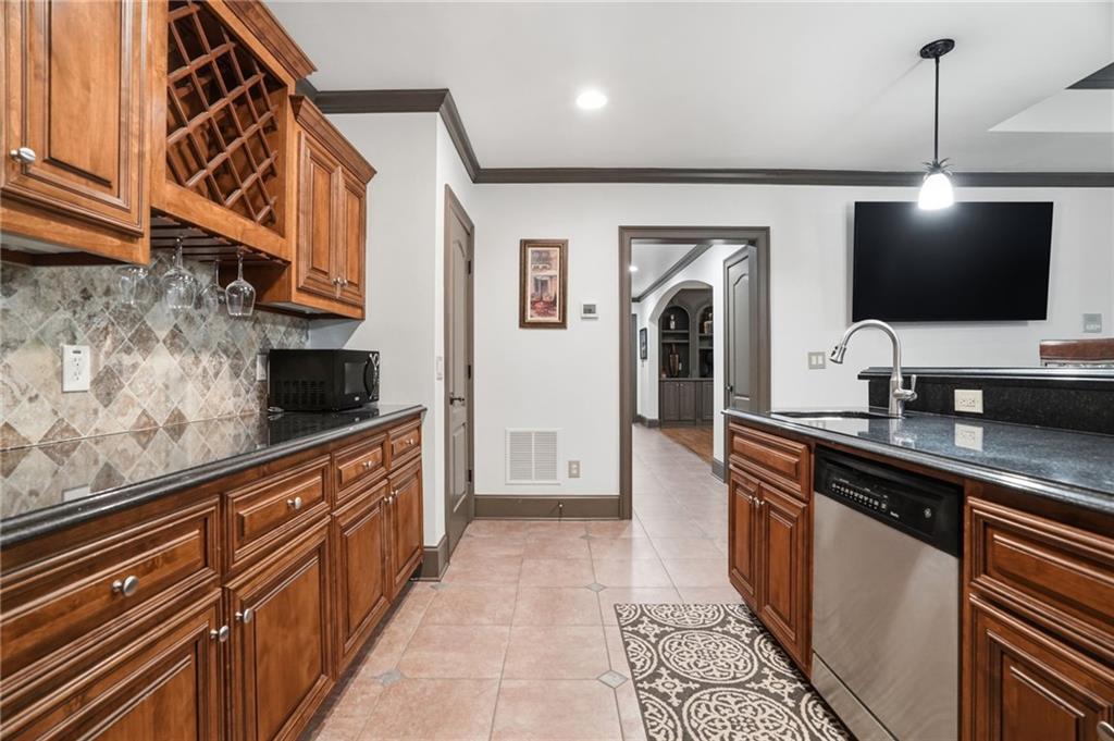 8340 Colonial Place Duluth, GA 30097 - Photo 44 of 74 a large kitchen with stainless steel appliances granite countertop a stove and a sink