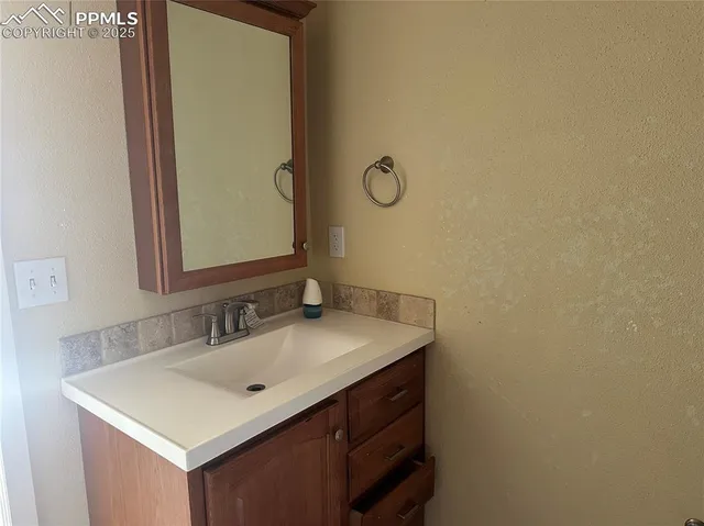 a bathroom with a granite countertop toilet and a bathtub