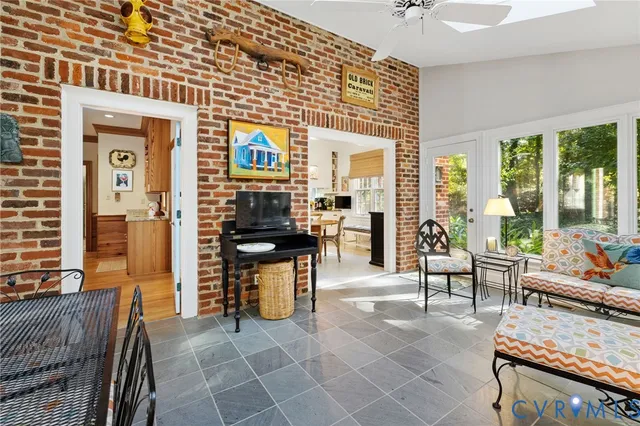 a living room with furniture a large window and chairs