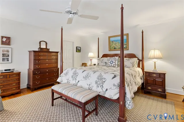 a bedroom with a bed a dresser and chair