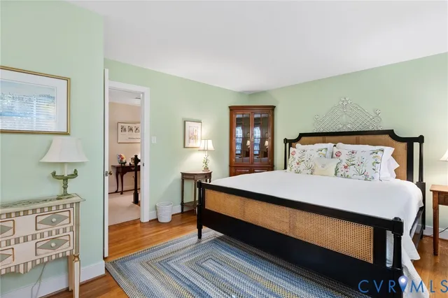 a bed sitting in a bedroom next to a window with a dresser