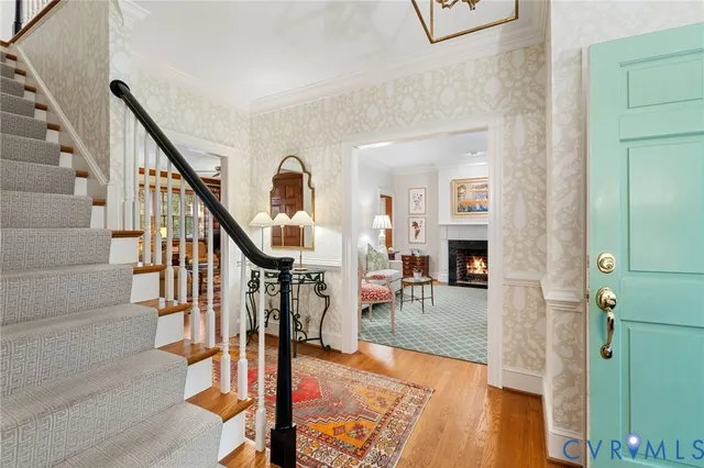 a view of an entryway with wooden floor and a livingroom view