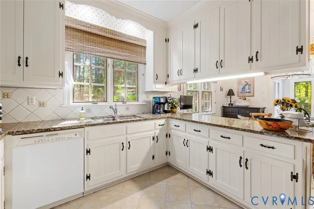 a kitchen with granite countertop white cabinets and white appliances
