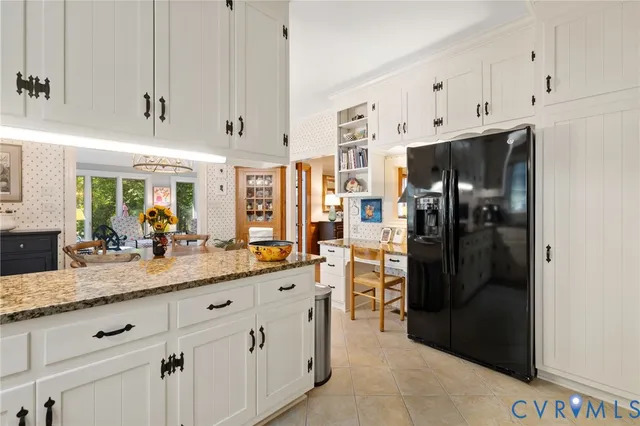 a kitchen with stainless steel appliances a refrigerator and cabinets