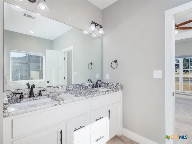 a bathroom with a sink double vanity and a mirror