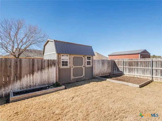 a view of a house with wooden fence