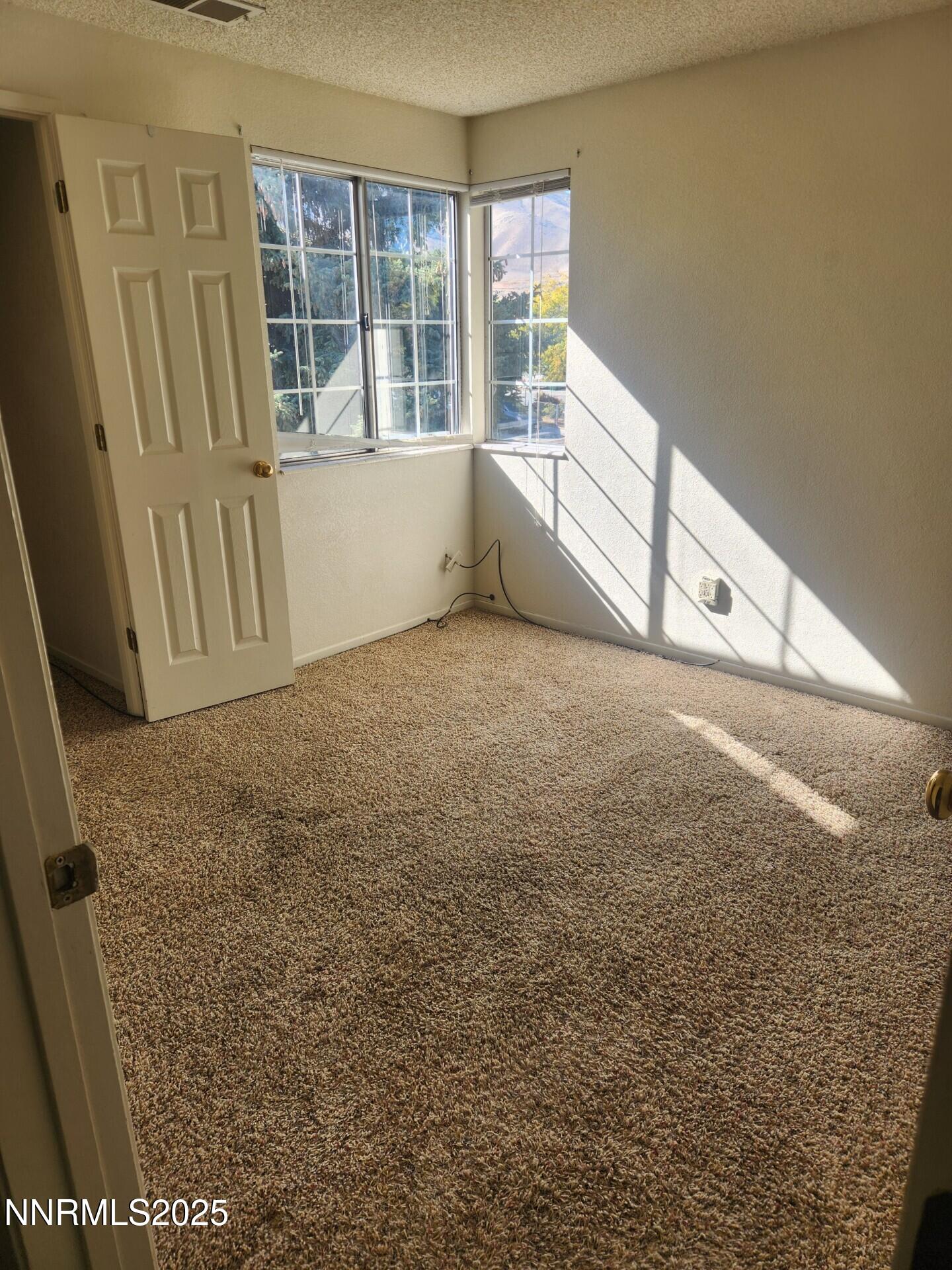 7663 Crystal Shores Drive Reno, NV 89506 - Photo 2 of 10 a view of an empty room with a window