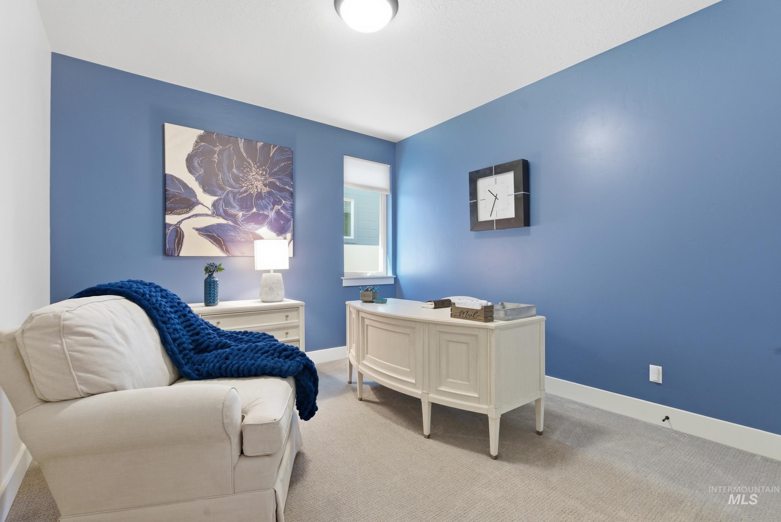6347 South Utmost Lane Meridian, ID 83642 - Photo 19 of 37 Room featuring blue walls with white trim, a recessed window, and light-colored carpeting