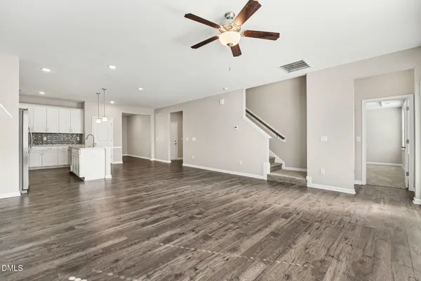a view of empty room with wooden floor and window