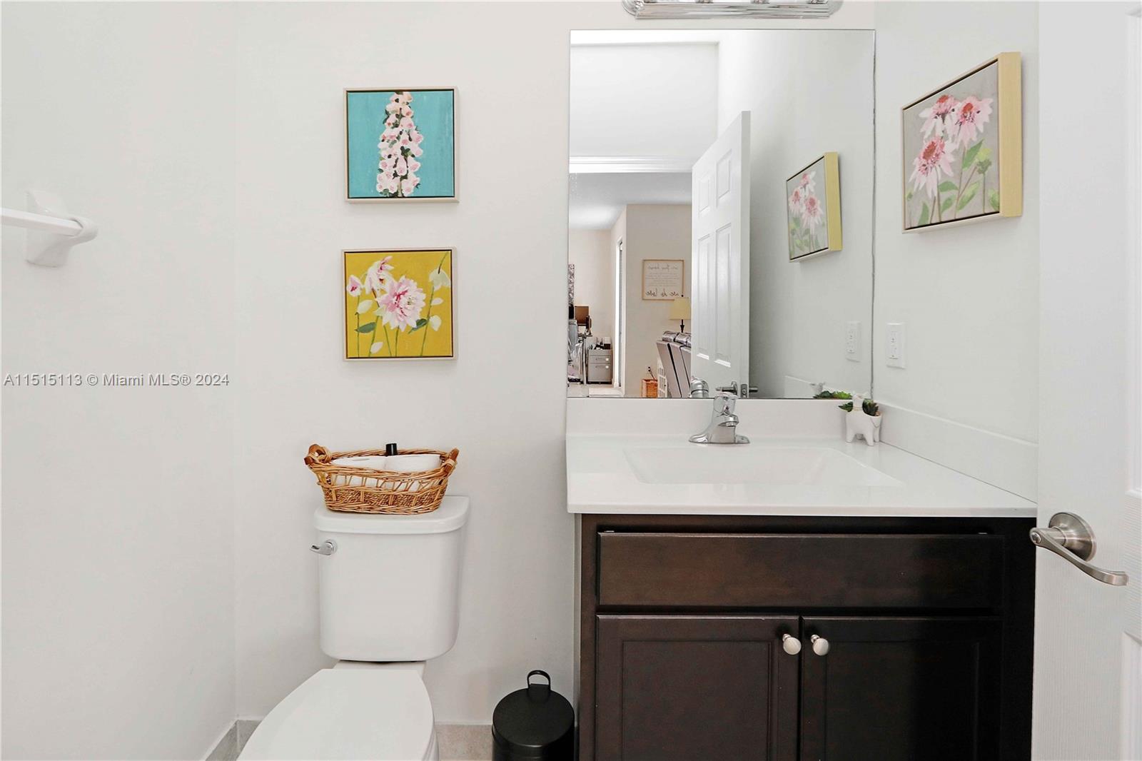 3448 Southeast 3rd Street Homestead, FL 33033 - Photo 11 of 27 a bathroom with a sink a toilet and a mirror
