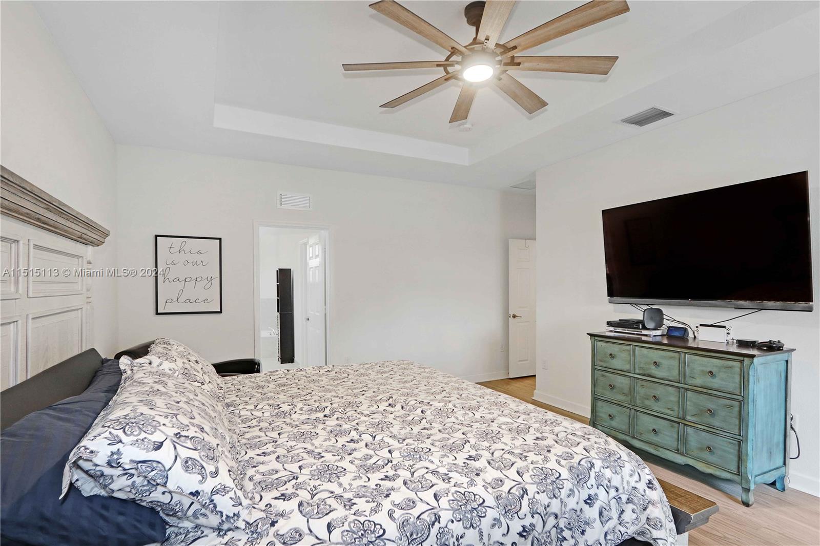 3448 Southeast 3rd Street Homestead, FL 33033 - Photo 13 of 27 a bedroom with a bed and a flat screen tv