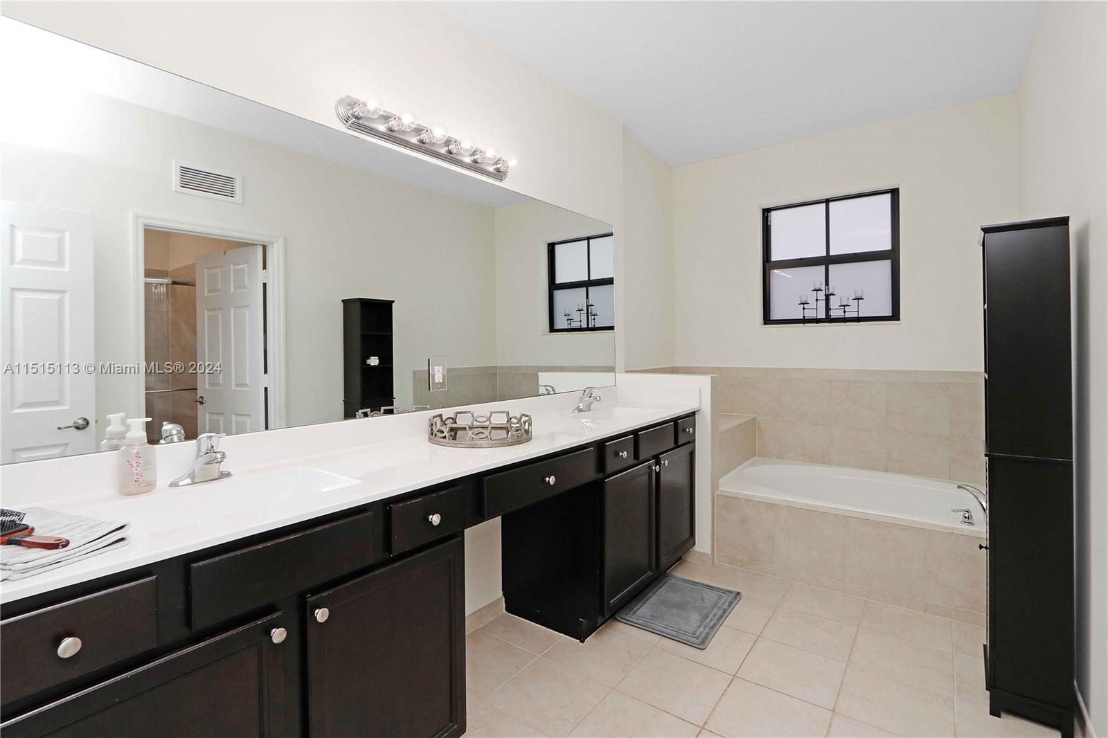 3448 Southeast 3rd Street Homestead, FL 33033 - Photo 15 of 27 a bath room with a sink vanity and a mirror