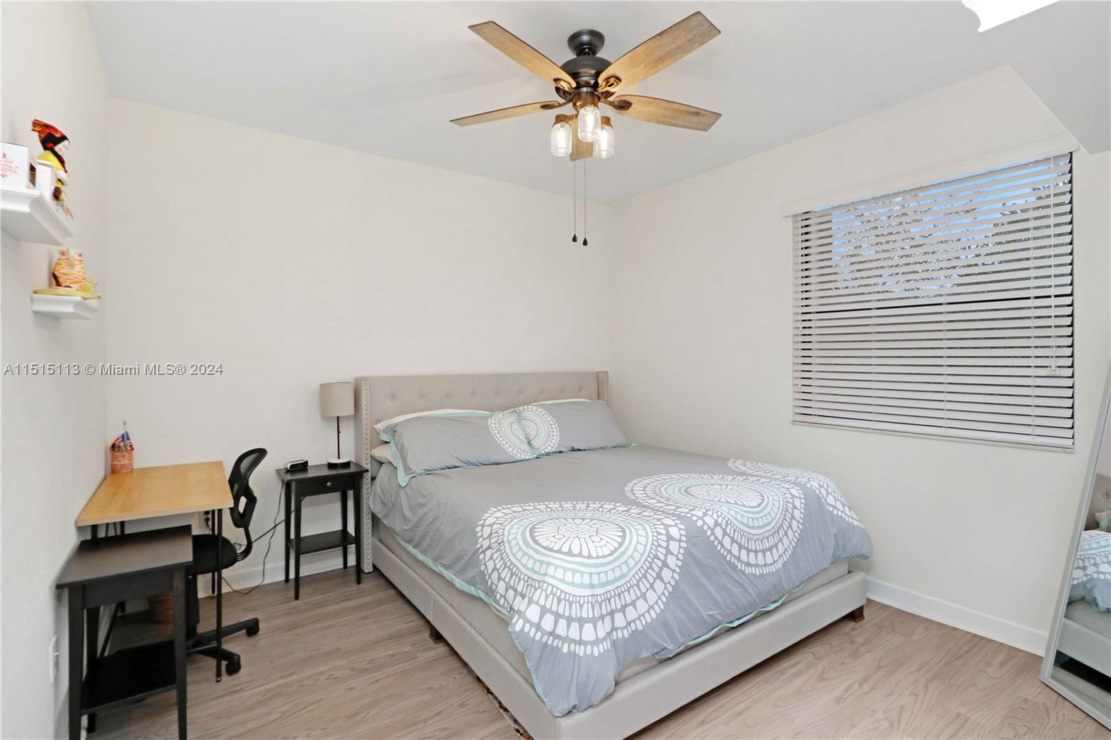 3448 Southeast 3rd Street Homestead, FL 33033 - Photo 17 of 27 a bedroom with a bed and a chandelier
