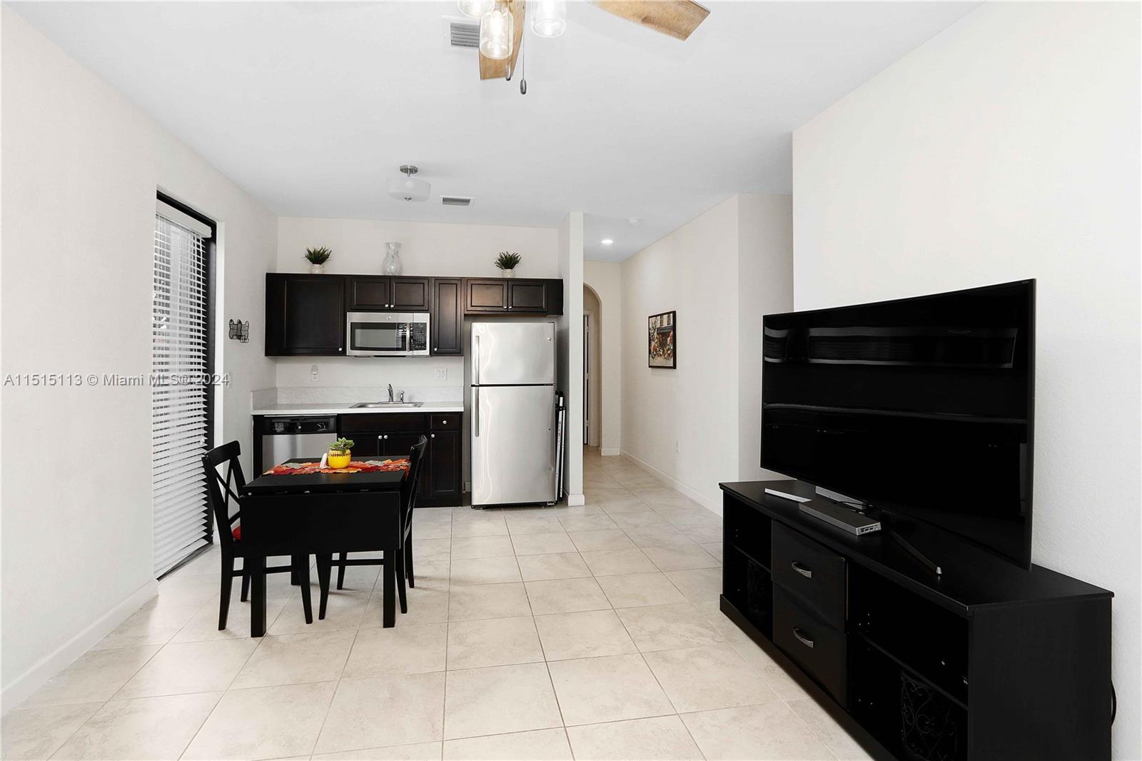 3448 Southeast 3rd Street Homestead, FL 33033 - Photo 22 of 27 a kitchen with stainless steel appliances a stove refrigerator and a microwave