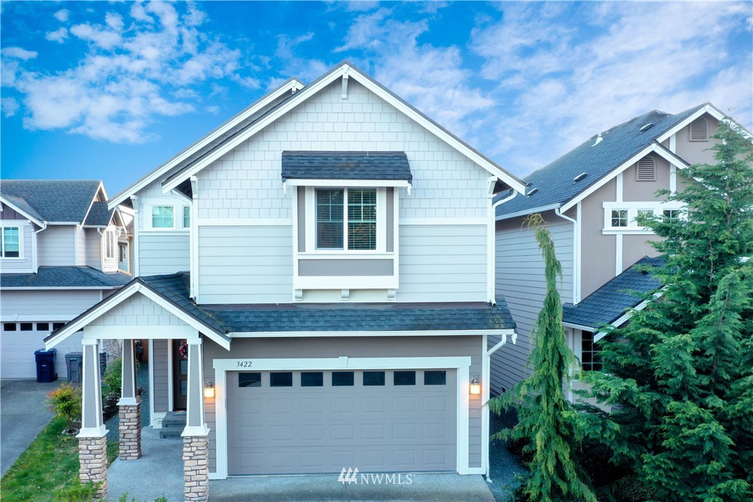 3422 181st Place Southeast Bothell, WA 98012 - Photo 1 of 22 a front view of a house with a yard and garage