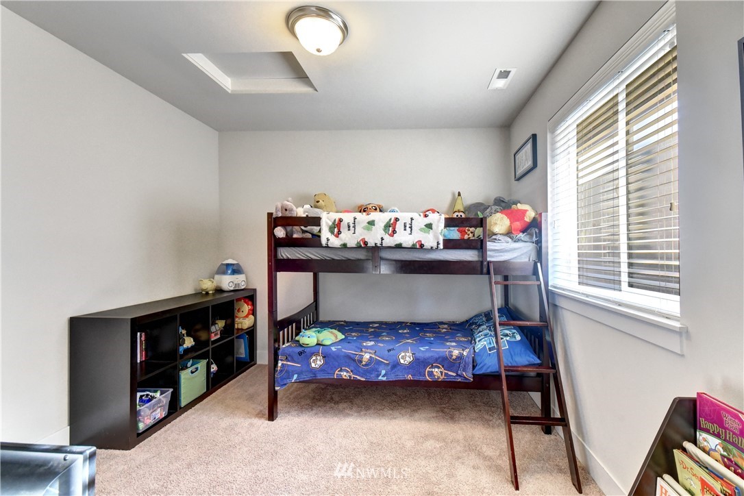 3422 181st Place Southeast Bothell, WA 98012 - Photo 16 of 22 a bedroom with furniture and a lamp