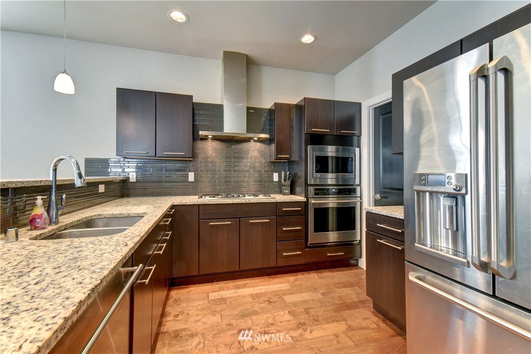 3422 181st Place Southeast Bothell, WA 98012 - Photo 3 of 22 a kitchen with stainless steel appliances granite countertop a refrigerator and a sink