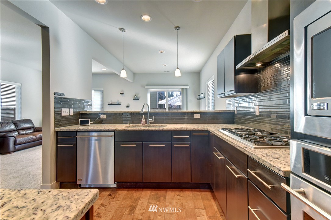3422 181st Place Southeast Bothell, WA 98012 - Photo 4 of 22 a kitchen with stainless steel appliances granite countertop a stove sink and cabinets