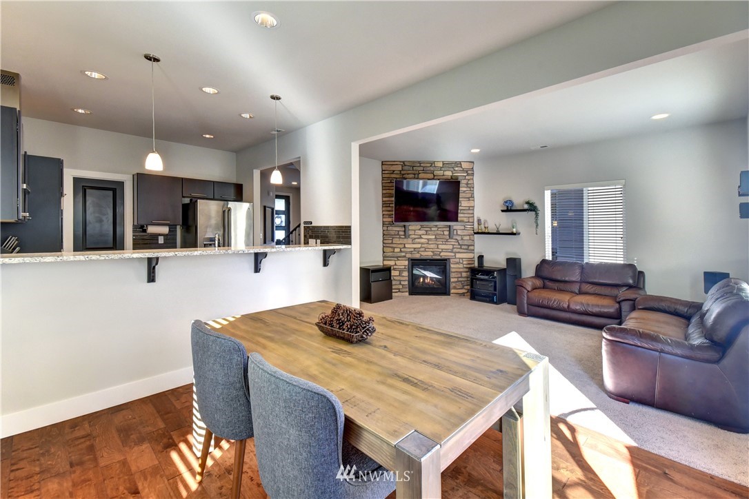 3422 181st Place Southeast Bothell, WA 98012 - Photo 6 of 22 a living room with fireplace furniture and a flat screen tv