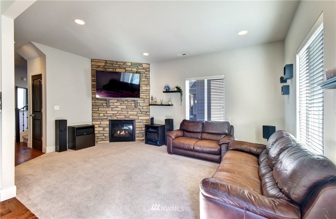 3422 181st Place Southeast Bothell, WA 98012 - Photo 7 of 22 a living room with furniture a flat screen tv and a fireplace