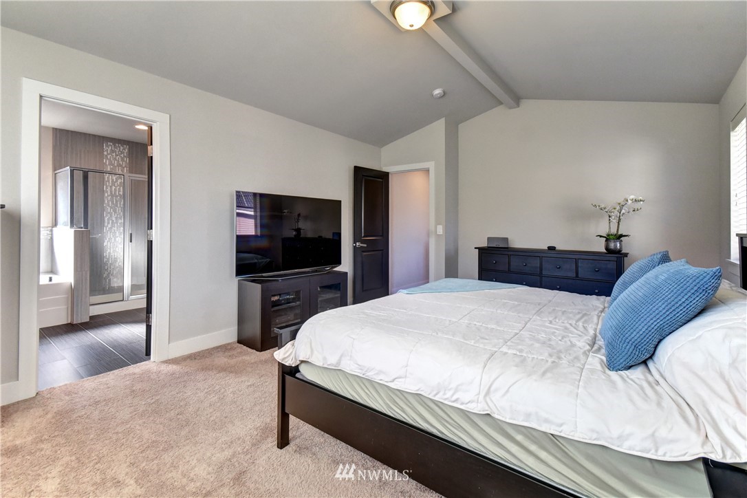 3422 181st Place Southeast Bothell, WA 98012 - Photo 9 of 22 a bedroom with a bed and a flat screen tv